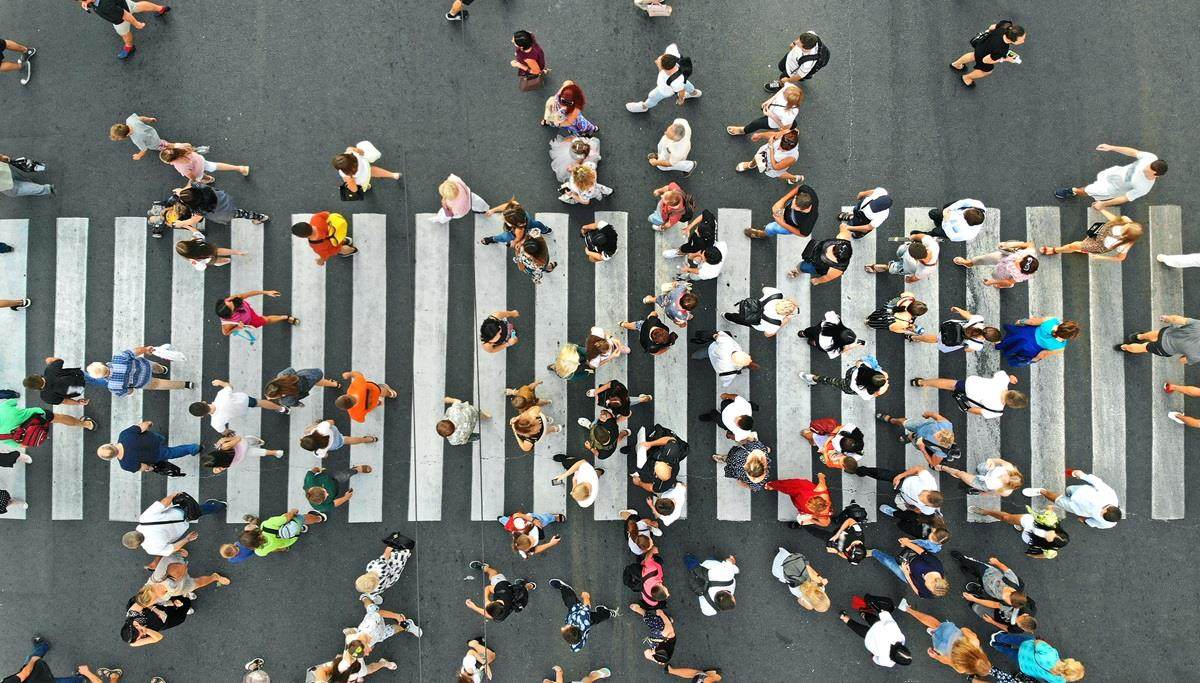 humans walking across street