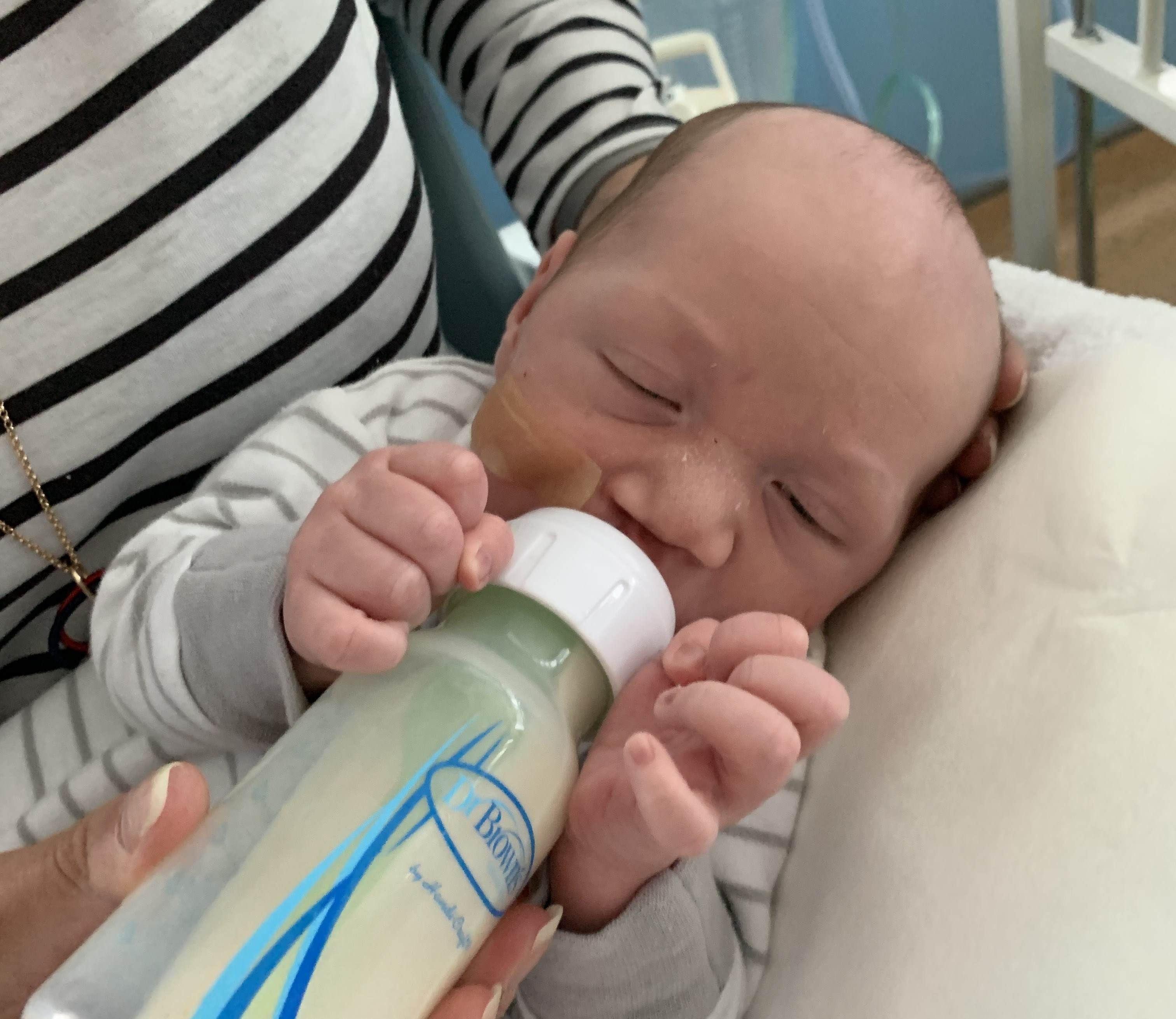 Baby feeding thanks to CLAPA-provided bottle